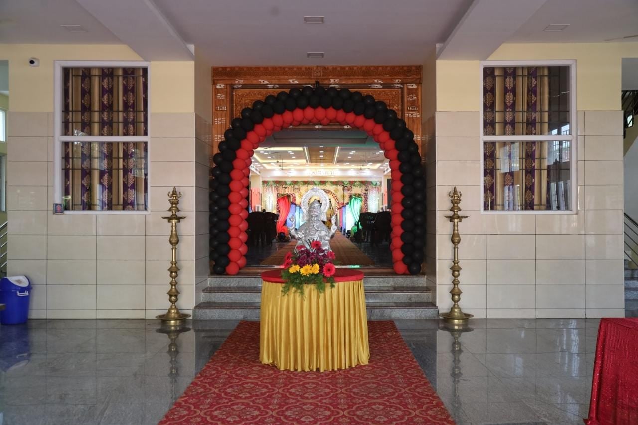 Entrance lobby with Ganesha, brass lamps and a balloon arch