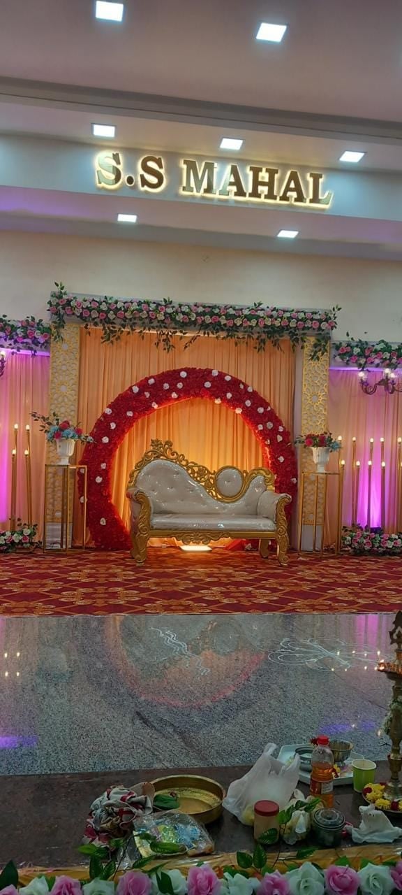 Red floral arch stage for a family function